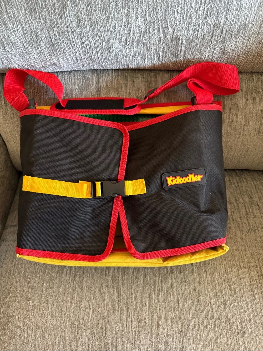 Kids travel activity organizer features a fold-out flat play surface. See detail